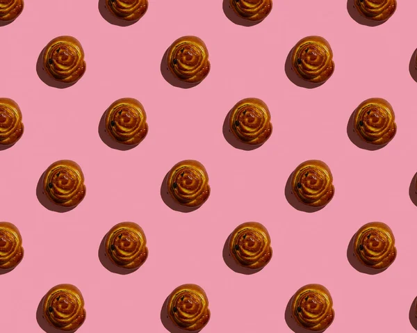 Pembe arkaplan desenli Cinnabon çöreği — Stok fotoğraf