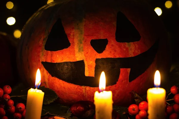 Creepy smiling pumpkin in the candlelight for halloween.