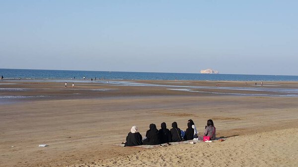  Beautiful scenery of Qurum Beach ,some local females hanging out to enjoy the view, Sultanate of Oman.