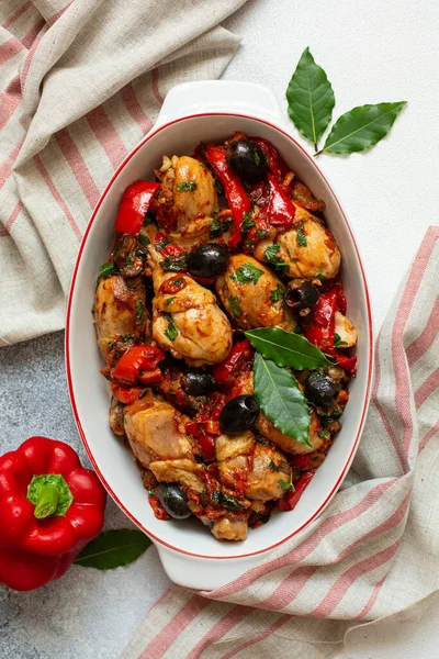 stock image Chicken cacciatore - hunter-style italian chicken with tomatoes, black olives and red bell peppers. White background.