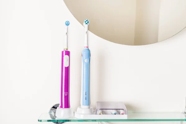 Electric Rechargeable Toothbrushes Bathroom Shelf Light Background — Stock Photo, Image