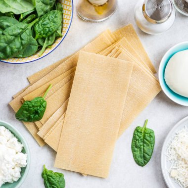 Vejetaryen ıspanak ve Ricotta lazanya, üstten görünüm, gri arka plan için malzemeler 