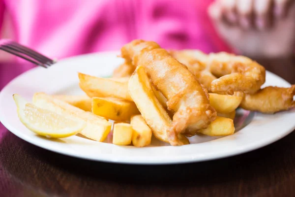 Traditional English Food such as Fish and Chips with green peas served in the Pub or Restaurant