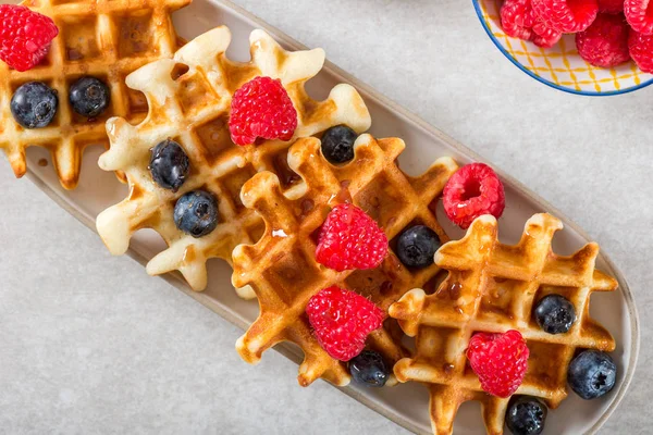 Traditional homemade belgian waffles with fresh berries and syru