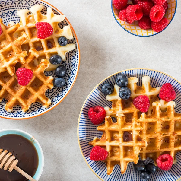 Traditional homemade belgian waffles with fresh berries and syru