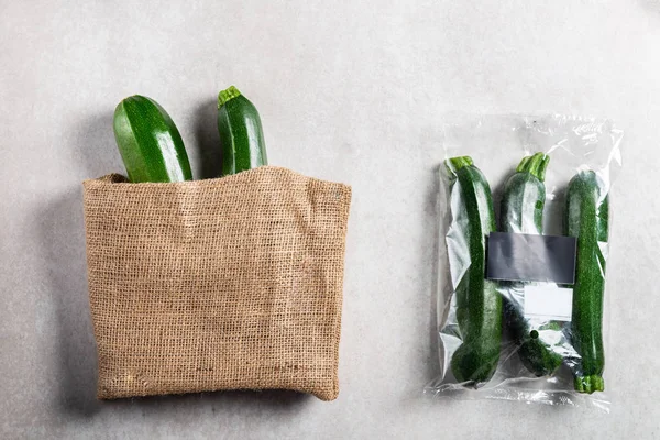 Courgettes in plastic bag VS paper bag. Choose less plastic concept