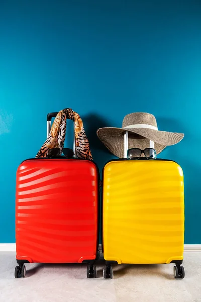 Bright and stylish cabin size suitcases and accessories as holiday concept