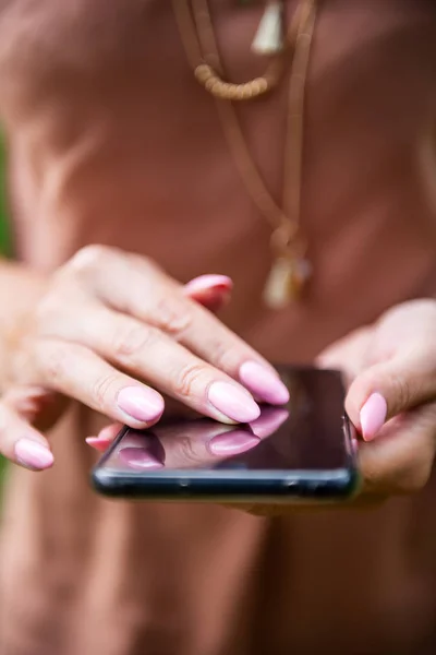 Beautiful slim lady is using her smartphone