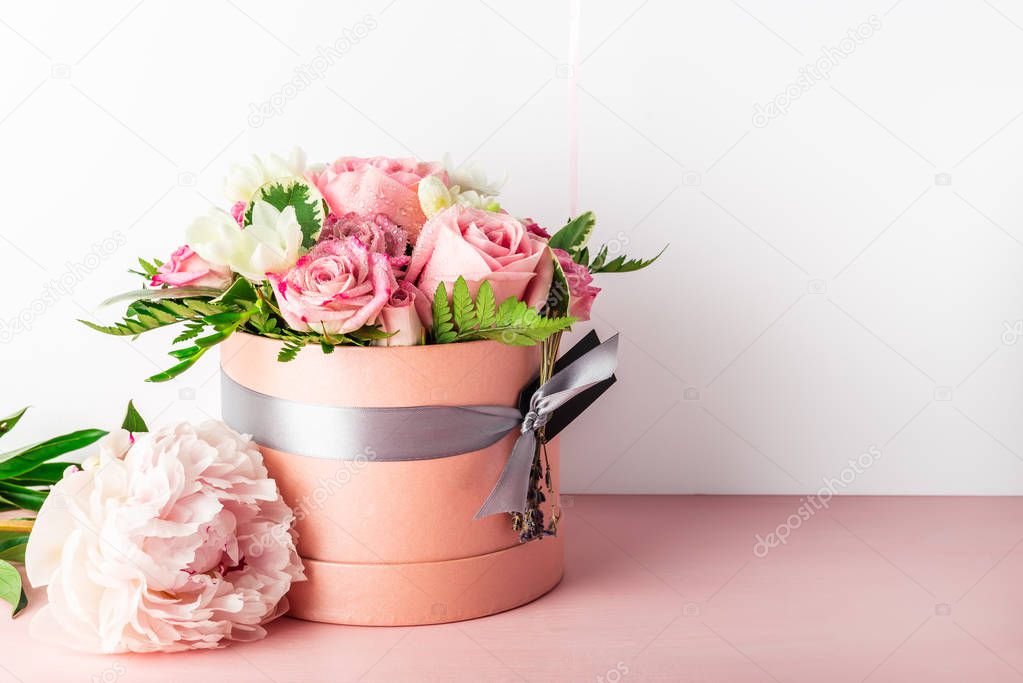 Beautiful and tender bouquet of flowers in the hat box,