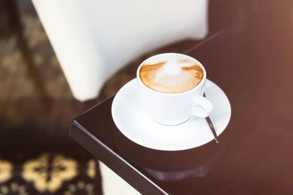 Flat white coffee on the table in the cafe