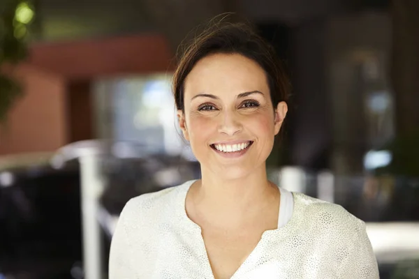 Confident and smiling woman looking at camera , portrait