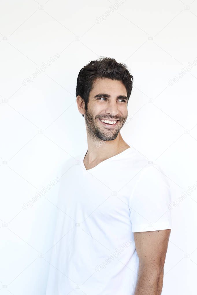 Man in white smiling and looking over shoulder