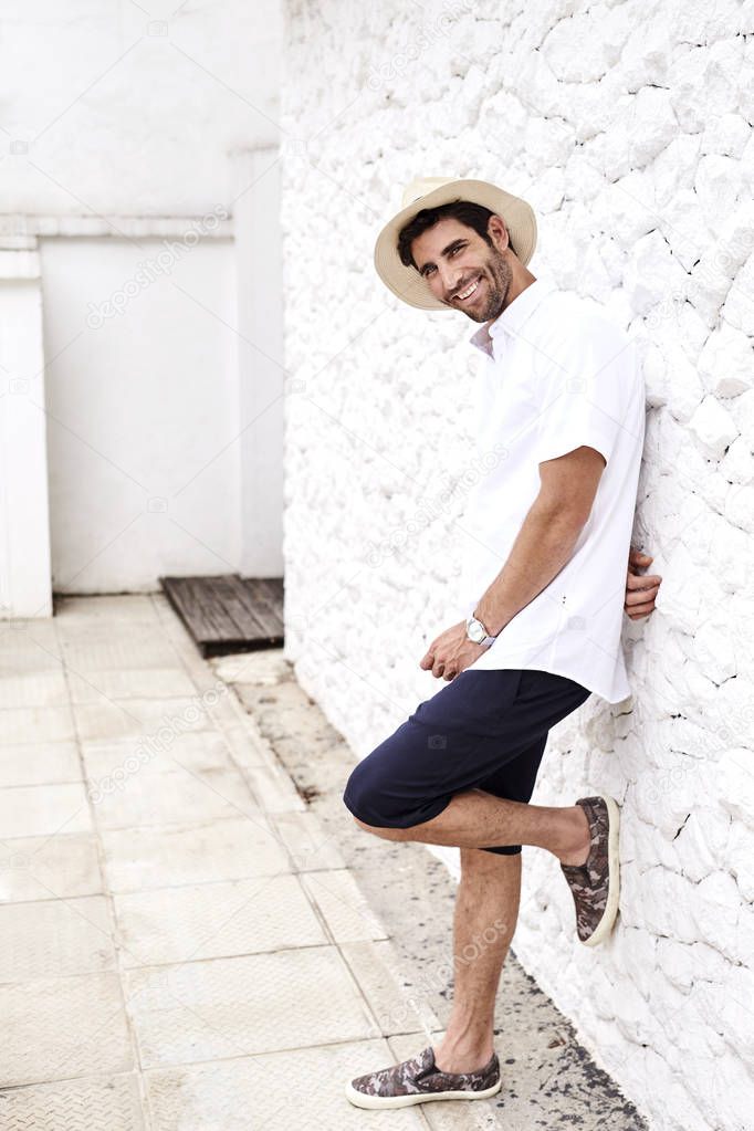 Smiling guy in shorts and hat, portrait