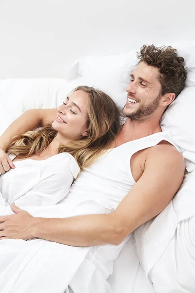 微笑的年轻夫妇在床上放松 — 图库照片