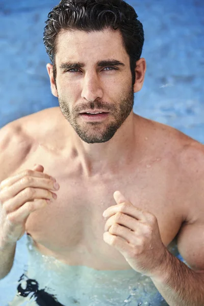 guy in Pool with stubble looking to camera