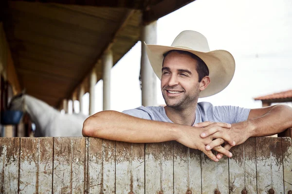 Smiling Cowboy Leaning Fence Looking Away — Stock Photo, Image