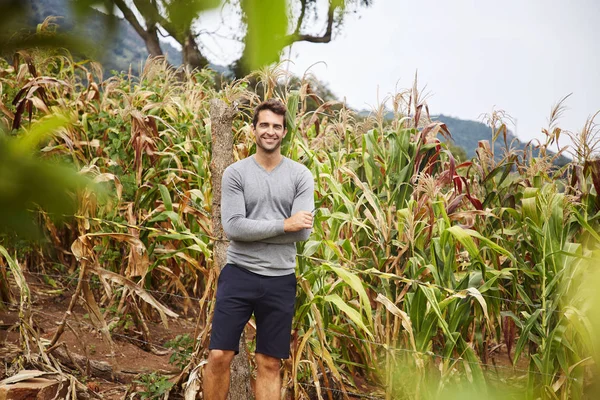 Good looking guy by field in countryside, portrait