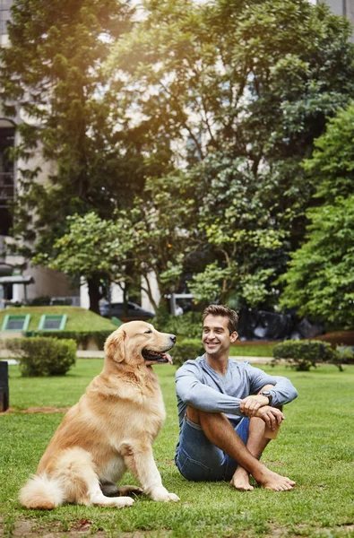 Happy guy with man's best friend in ark, smiling