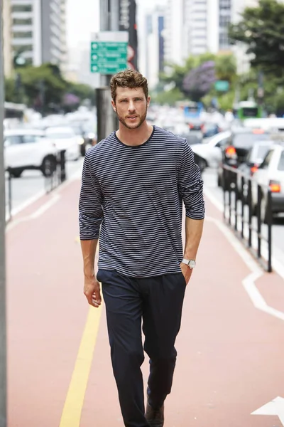 Young good looking guy walking in city, portrait