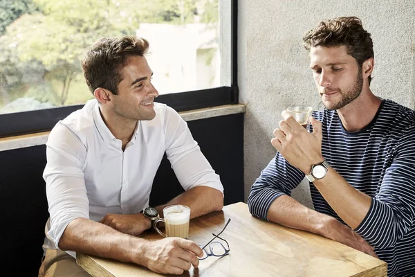 Two friends chatting over coffee