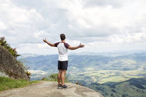 Man amazed at view, arms out