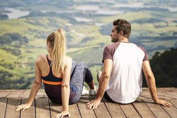 Sportswear couple relaxing by view