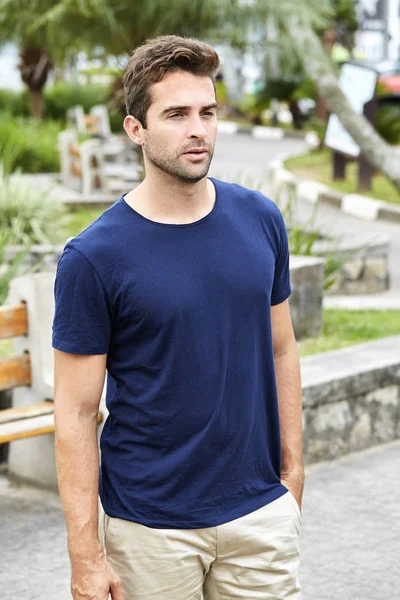 Good looking guy in blue t-shirt, looking away