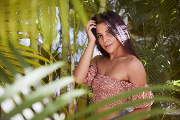 Beautiful woman amongst plants, portrait