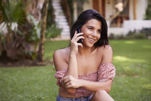 Beautiful young woman on the phone, smiling