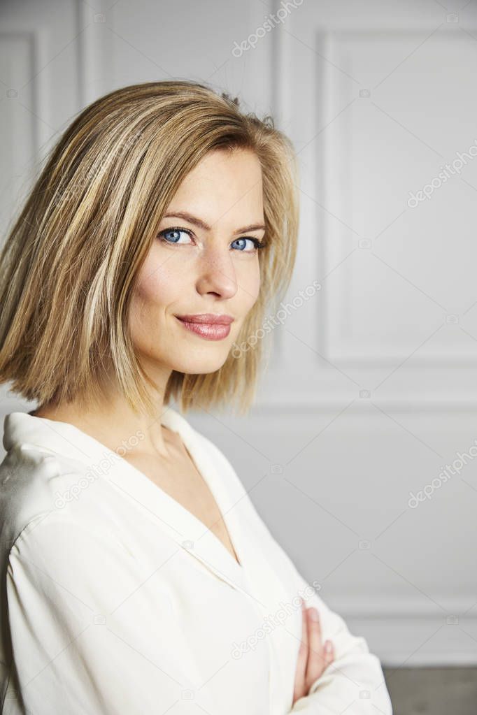 Blue eyed blond girl in white, portrait