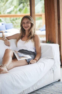 Güzel kız kanepe ile dergi, portre rahatlatıcı