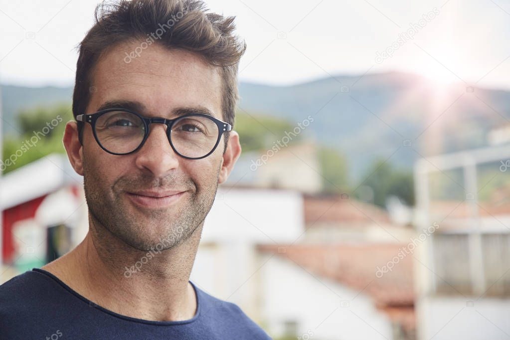 Good looking man in glasses, looking at camera