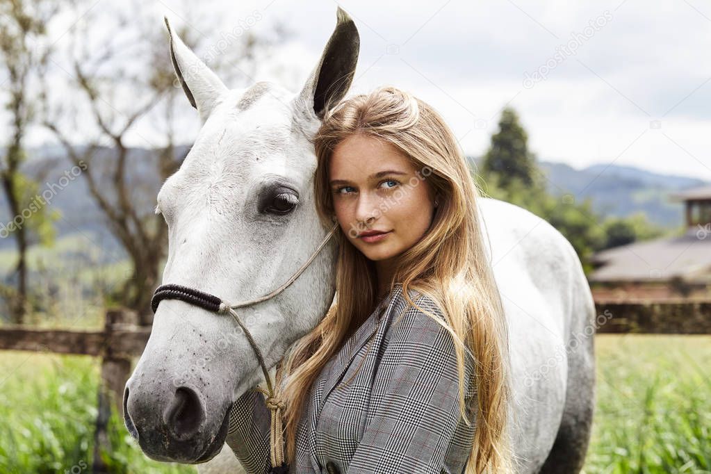 Beautiful blond woman with pony, looking at camera