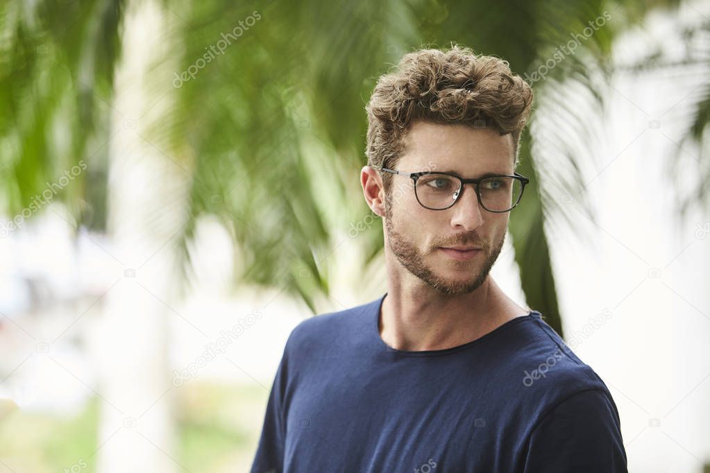 Bearded guy in glasses, looking over shoulder
