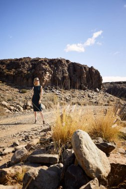 Çölde güzel model ayakta, uzağa bakıyor