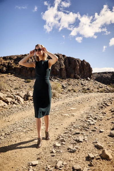 Stylish blond model walking in desert