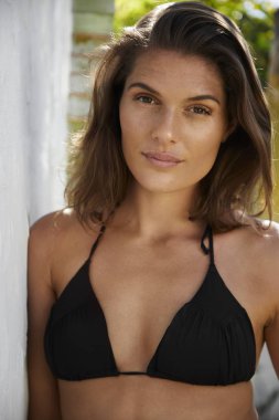 Bikinili güzel esmer kameraya gülümsüyor.
