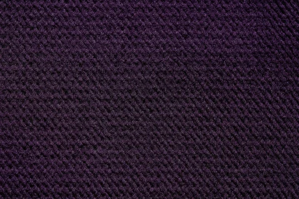 Dark fabric texture in violet tone. High resolution photo.