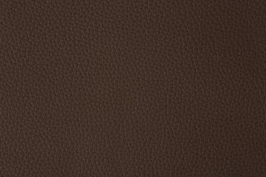 Kahverengi deri bir swatch bir bölümünün yakın genelinde tahıl ve ışık mili gösteren.