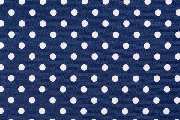 Navy blue white polka dots fabric texture.
