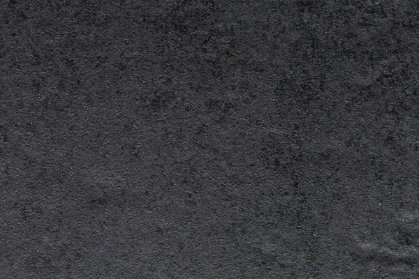 Strict synthetic stone background in dark grey tone.