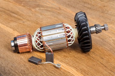 Electric motor rotor on old wooden table background. clipart