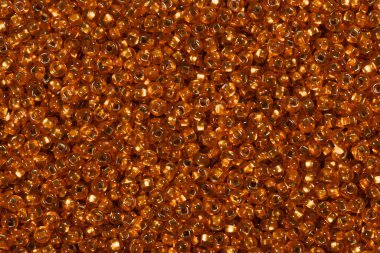 Arkaplan veya doku için altın portakal tohumu boncukları.