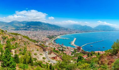 Alanya yarımadasında marina ve Kızıl Kule kulesi ile panoramik manzara, Antalya bölgesi, Türkiye, Asya. Yüksek dağlar ile ünlü turistik yer. Eski eski kalenin bir parçası. Yaz parlak gün