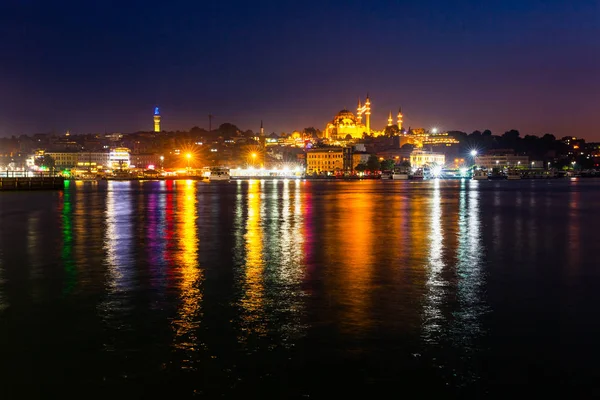 Night view of Istanbul. Panorama cityscape of famous tourist destination Golden Horn bay part of Bosphorus strait. Travel illuminated landscape Bosporus, Turkey, Europe and Asia.