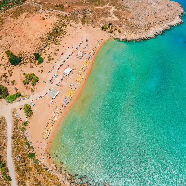 Aerial birds eye view drone photo Agia Agathi beach near Feraklos castle on Rhodes island, Dodecanese, Greece. Panorama with sand beach and clear blue water. Famous tourist destination in South Europe