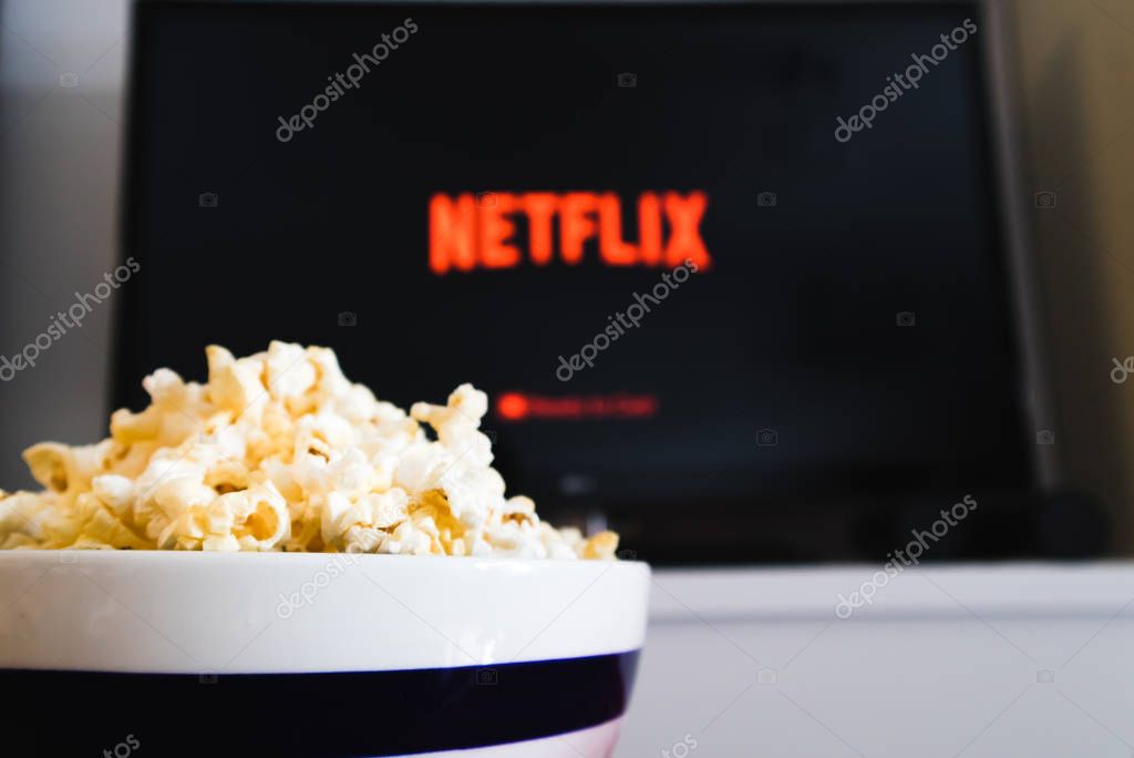 CHIANGMAI, THAILAND - JULY 4, 2019- Netflix logo on Smart TV and Popcorn bowl.Netflix is a global provider of streaming movies ,cartoon, Documentary and TV series.