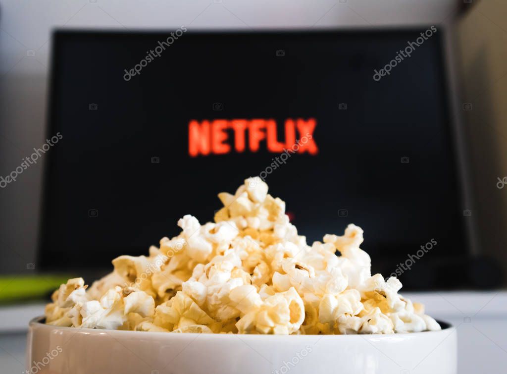 CHIANGMAI, THAILAND - JULY 5, 2019- Popcorn bowl and Netflix logo on Smart TV.Netflix is a global provider of streaming movies ,cartoon, Documentary and TV series.