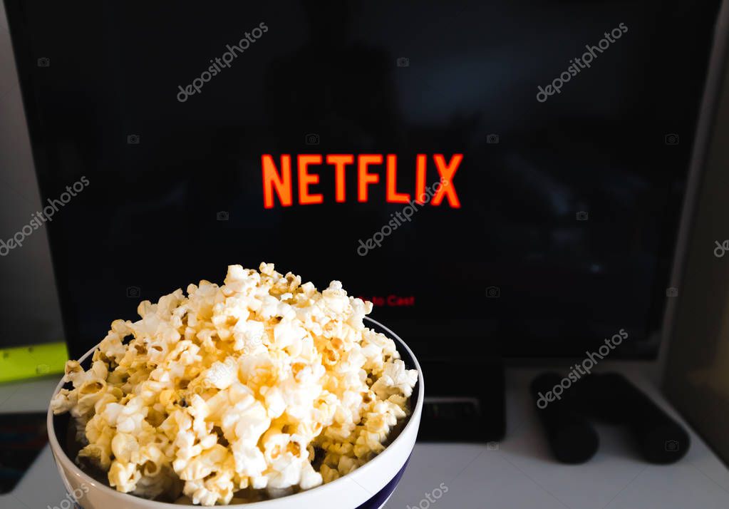 CHIANGMAI, THAILAND - JULY 7, 2019- Popcorn bowl and Netflix logo on Smart TV.Netflix is a global provider of streaming movies ,cartoon, Documentary and TV series.
