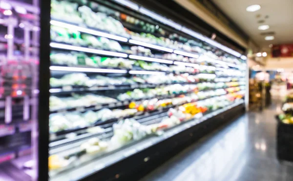 Blurred modern retail supermarket aisle shelves chilled vegetable zone